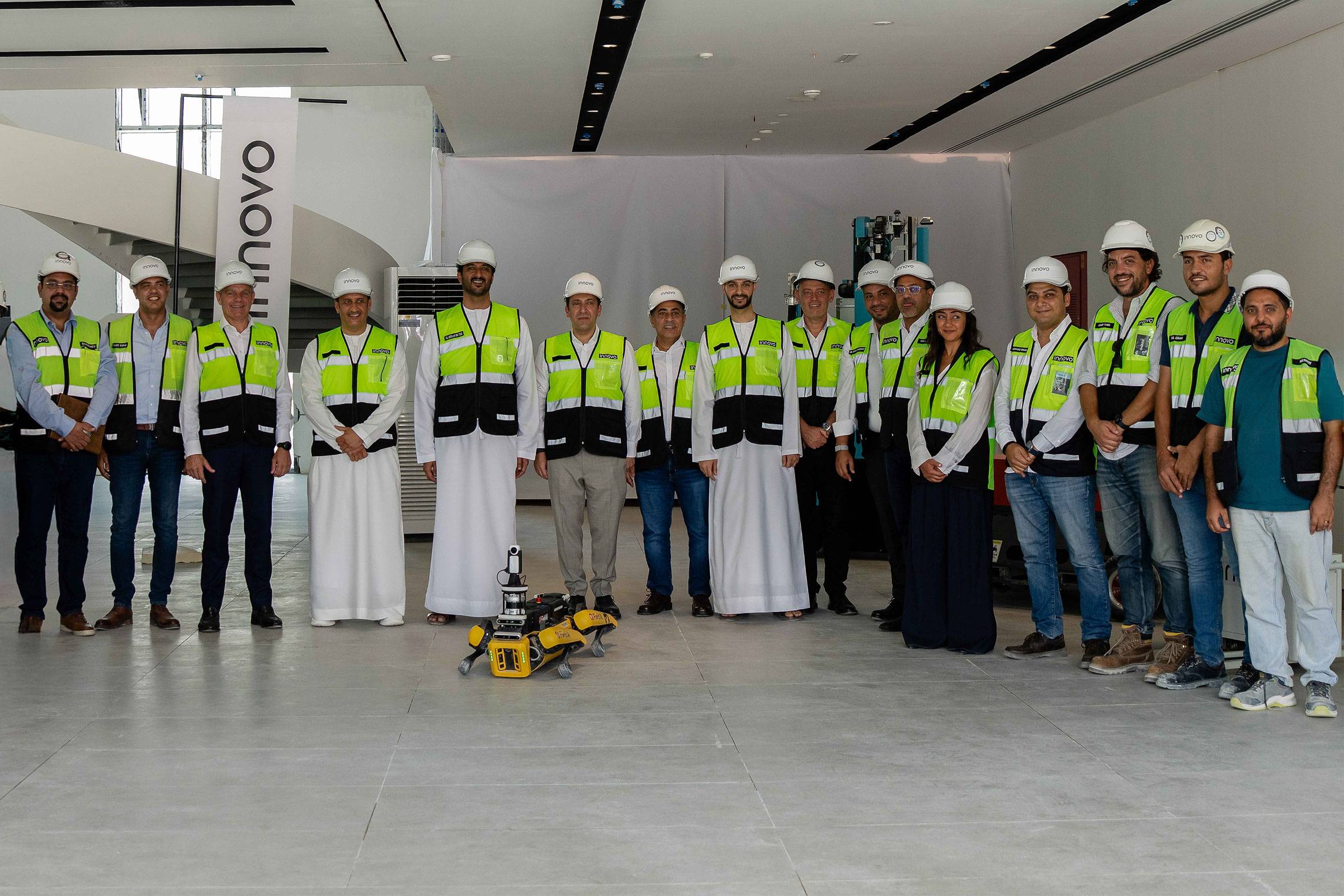 UAE officials and Innovo site team group photo with a robot dog at a Dubai project