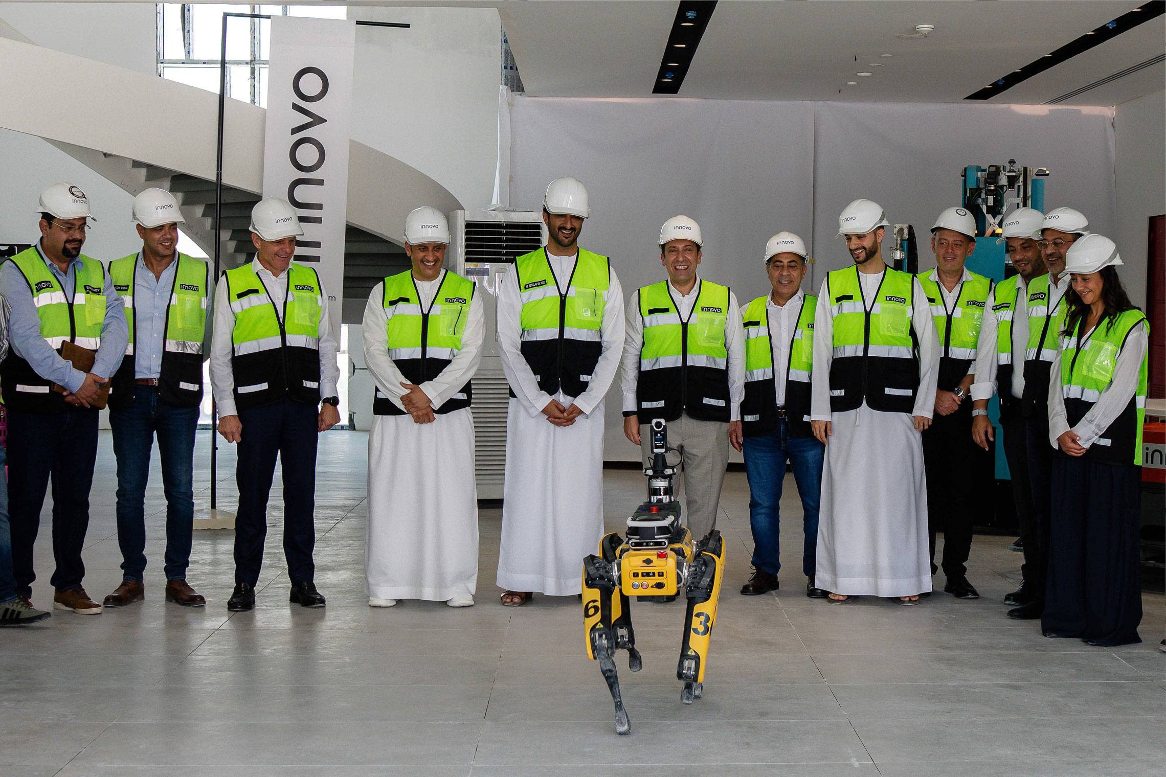 Innovo site team and UAE government delegation with a quadruped robot in Dubai