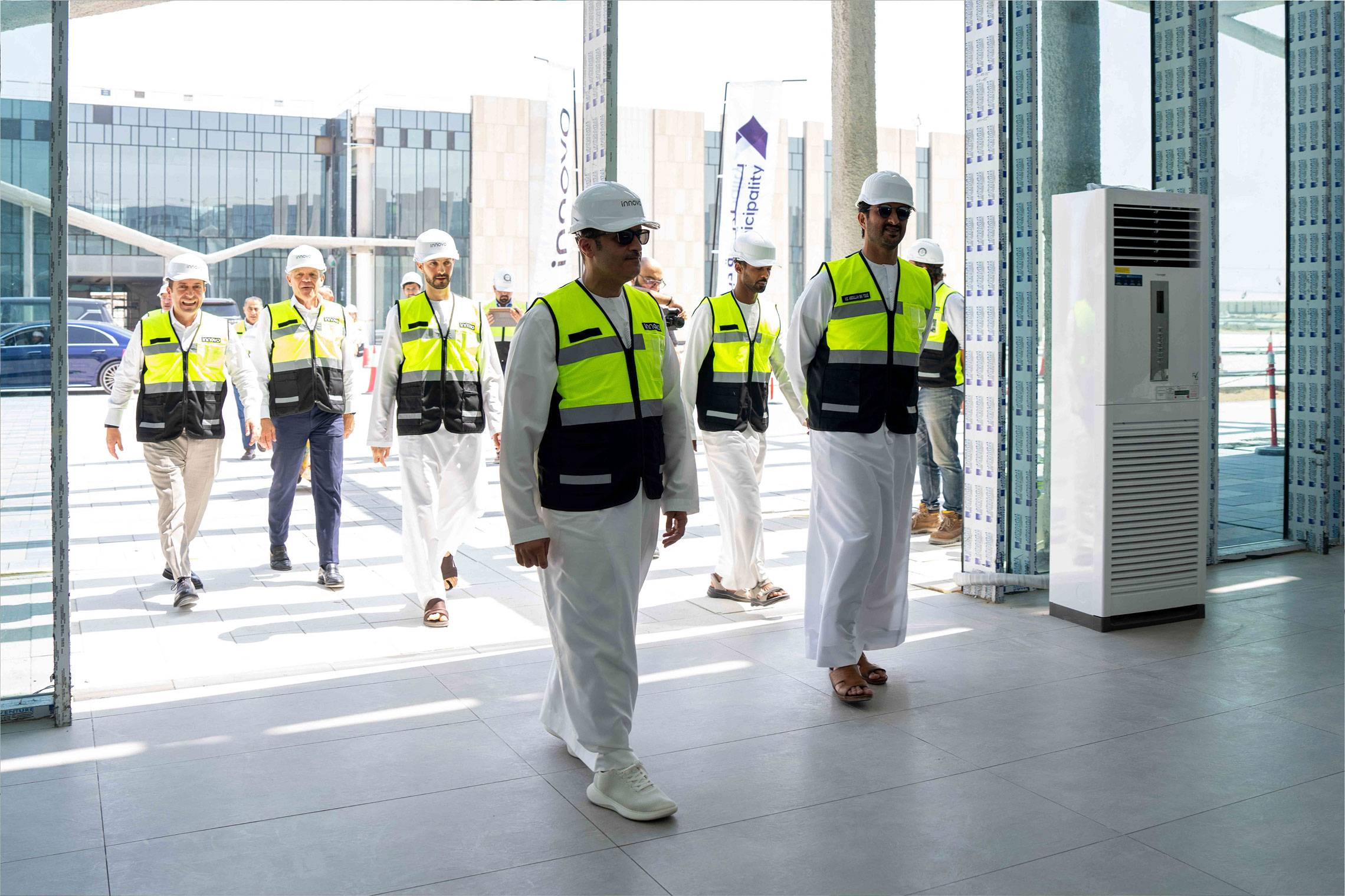 H.E. Abdulla bin Touq walks with Innovo site team in hard hats during Dubai site visit