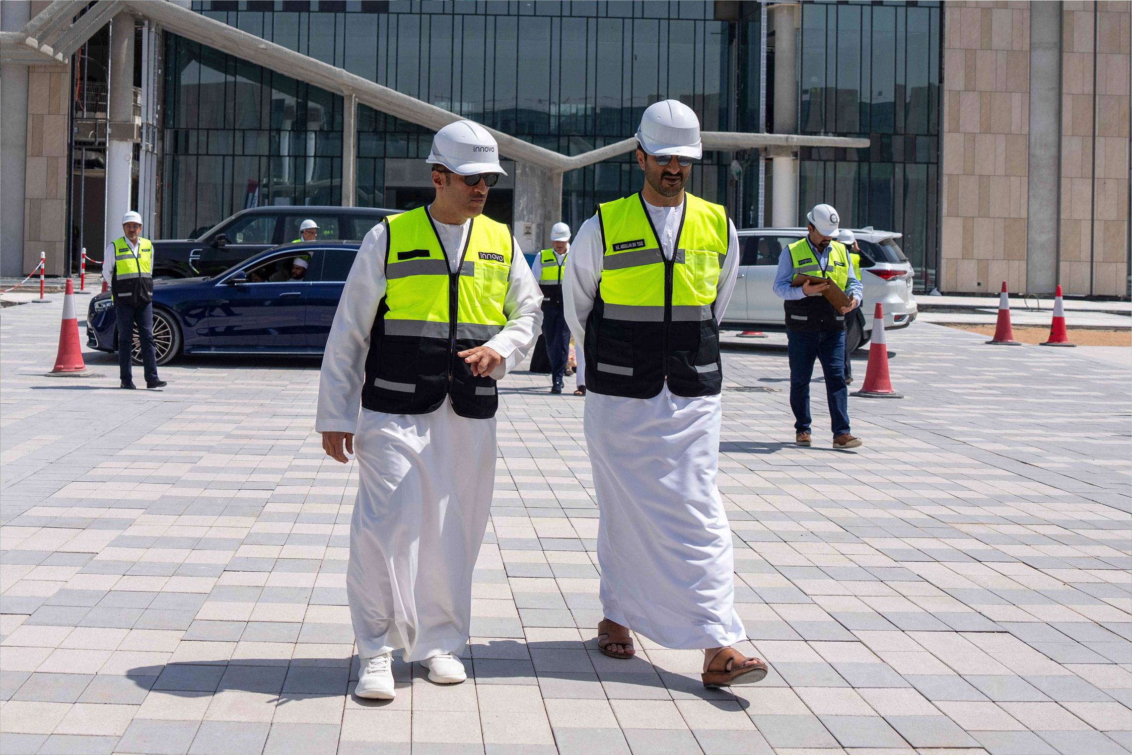H.E. Abdulla bin Touq walks with an Innovo executive outside a Dubai construction project